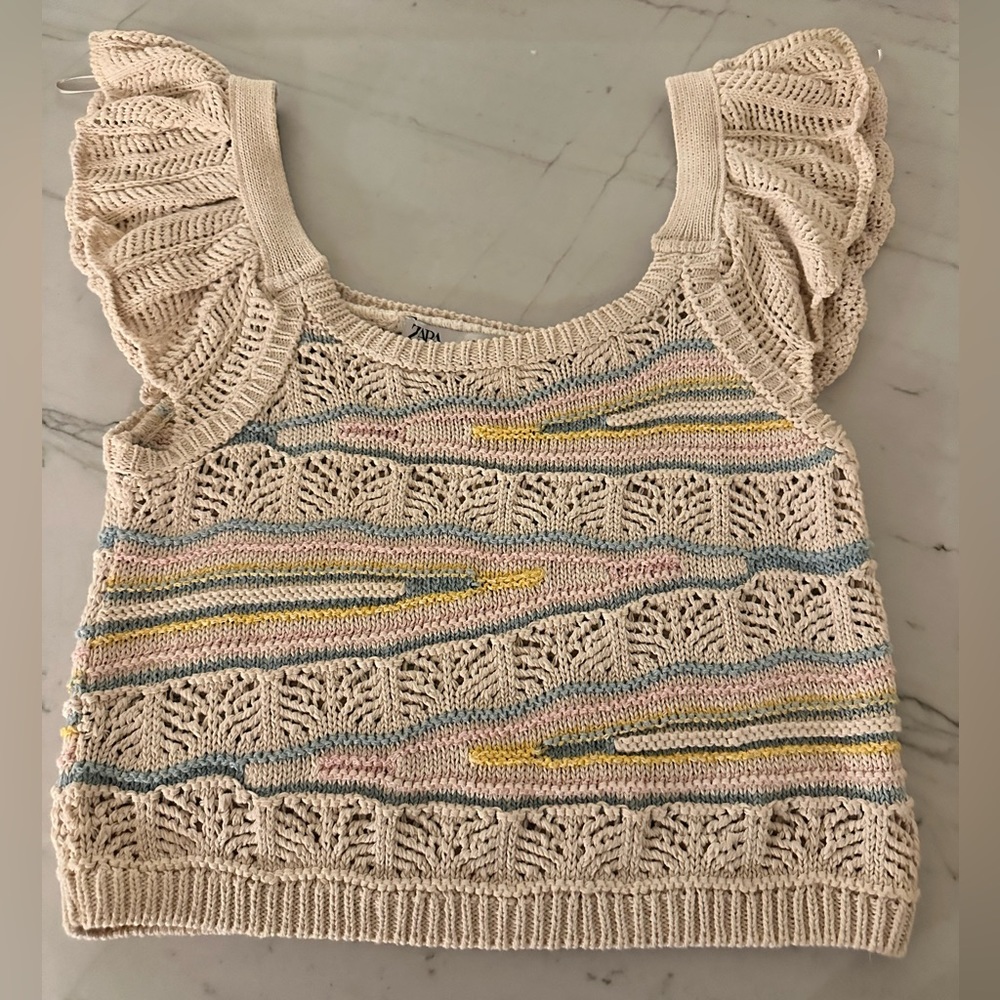 Knit Zara top. Ruffle sleeve detail. Tan with pink blue and yellow knit detail.